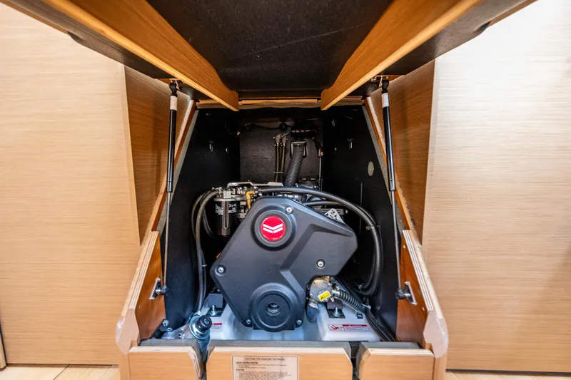 Into The Blue Yacht Photos Pics Engine compartment of 2022 Jeanneau Sun Odyssey 410 sailboat, showcasing modern design and functionality.