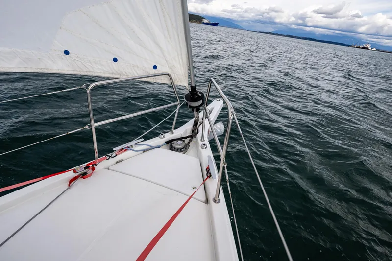 Into The Blue Yacht Photos Pics 2022 Jeanneau Sun Odyssey 410 sailing on open water under cloudy skies.