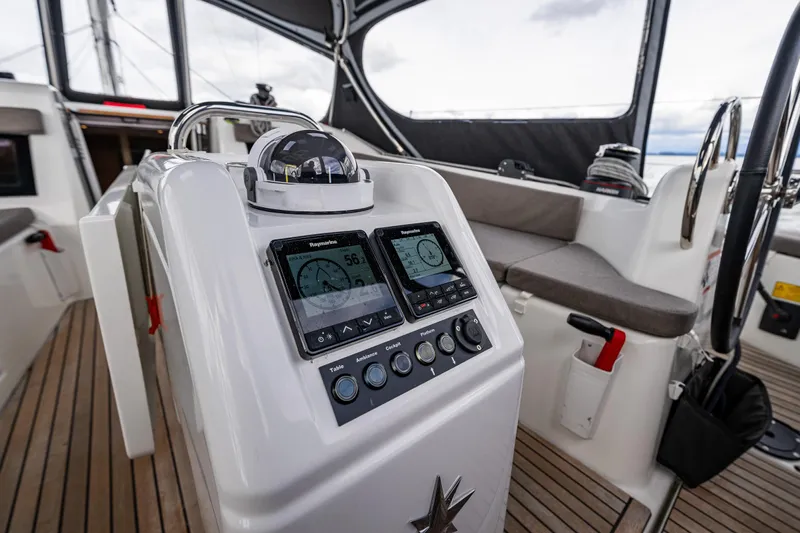 Into The Blue Yacht Photos Pics 2022 Jeanneau Sun Odyssey 410 cockpit with navigation instruments and seating.