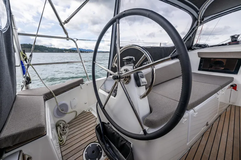 Into The Blue Yacht Photos Pics Cockpit of 2022 Jeanneau Sun Odyssey 410 sailboat with steering wheel and seating.