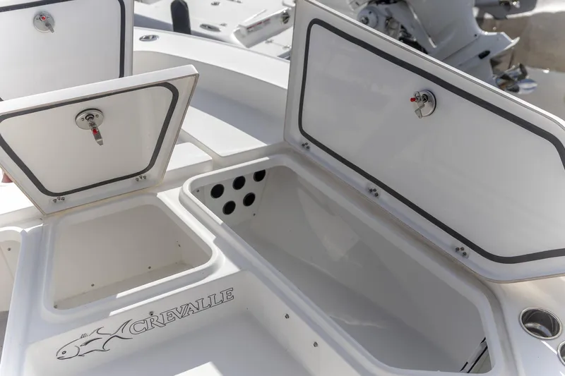  Yacht Photos Pics 2024 Crevalle 26 HCO boat storage compartments with open lids, showcasing interior space.