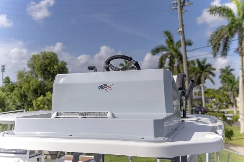 Yacht Photos Pics 2024 Crevalle 26 HCO boat console with steering wheel, outdoors with palm trees.