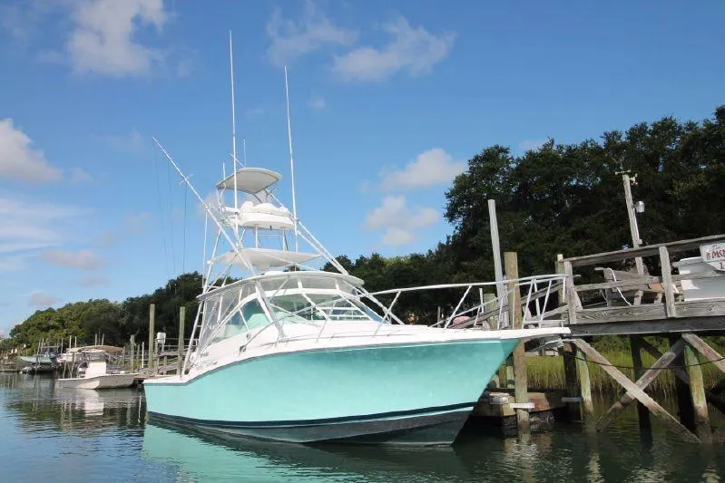 Reely Blessed Yacht Photos Pics 1998 Cabo 31 Express with Tower, docked at pier.