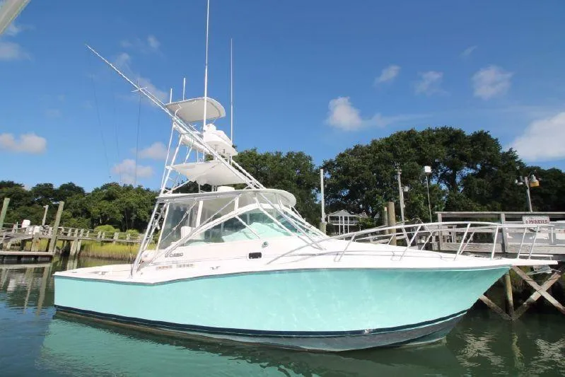 Reely Blessed Yacht Photos Pics 1998 Cabo 31 Express with Tower docked in water.
