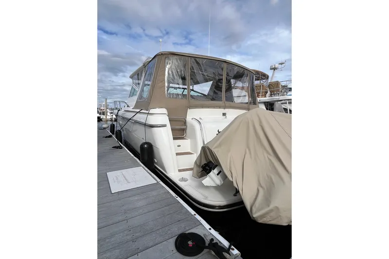 Summah Sled Yacht Photos Pics 1999 Tiara Yachts 4000 Express docked, featuring beige canopy and covered equipment.