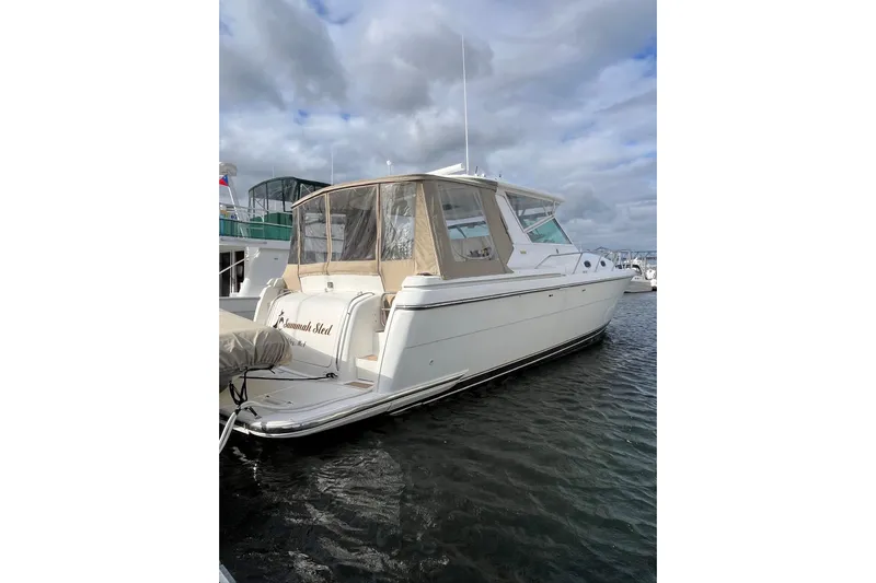 Summah Sled Yacht Photos Pics 1999 Tiara Yachts 4000 Express docked, featuring sleek design and spacious cabin.