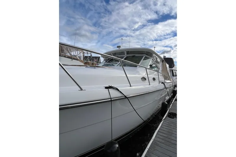 Summah Sled Yacht Photos Pics 1999 Tiara Yachts 4000 Express docked under a partly cloudy sky.