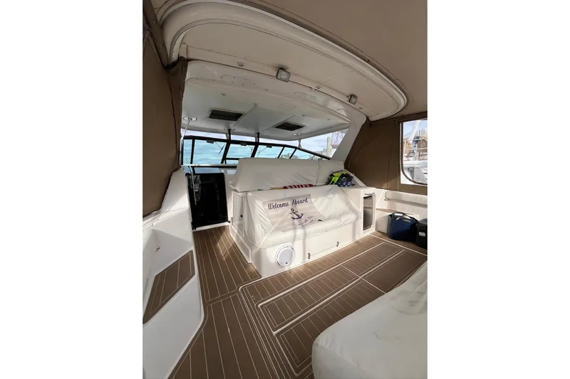Summah Sled Yacht Photos Pics 1999 Tiara Yachts 4000 Express interior with seating and nautical decor.