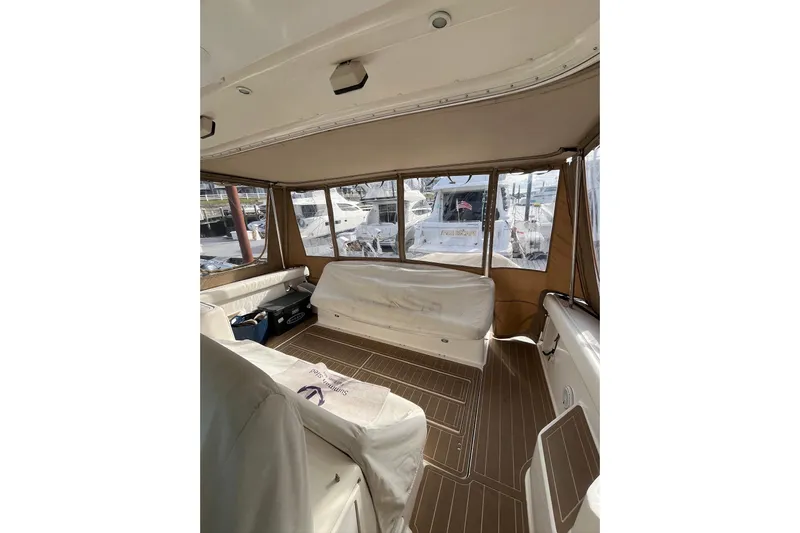 Summah Sled Yacht Photos Pics 1999 Tiara Yachts 4000 Express interior with covered seating and large windows.