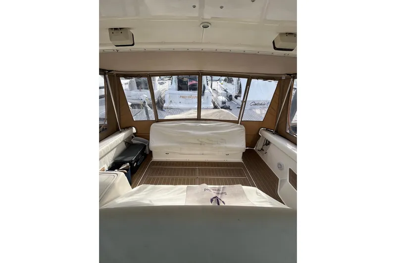 Summah Sled Yacht Photos Pics Interior view of 1999 Tiara Yachts 4000 Express, featuring spacious seating and windows.