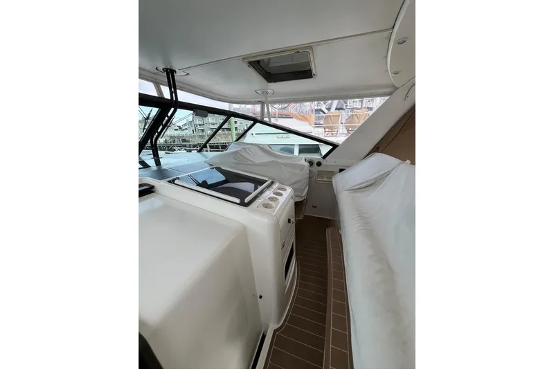 Summah Sled Yacht Photos Pics 1999 Tiara Yachts 4000 Express interior with covered seating and helm station.