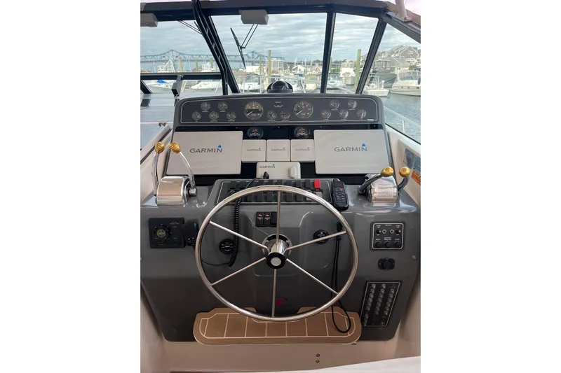 Summah Sled Yacht Photos Pics 1999 Tiara Yachts 4000 Express helm with Garmin navigation, docked in marina.