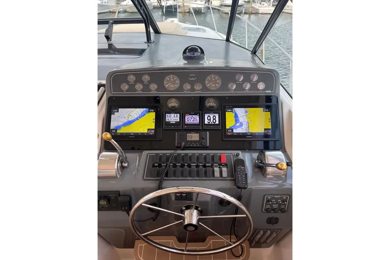 Summah Sled Yacht Photos Pics 1999 Tiara Yachts 4000 Express dashboard with navigation screens and controls.