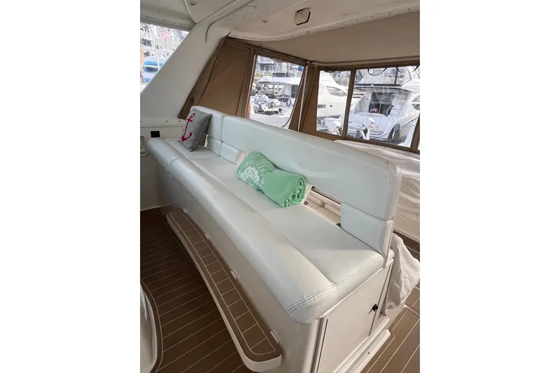 Summah Sled Yacht Photos Pics 1999 Tiara Yachts 4000 Express interior with white seating and nautical decor.