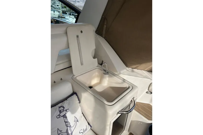 Summah Sled Yacht Photos Pics 1999 Tiara Yachts 4000 Express interior with sink and nautical-themed pillow.