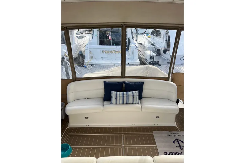 Summah Sled Yacht Photos Pics 1999 Tiara Yachts 4000 Express interior with white seating and nautical decor.