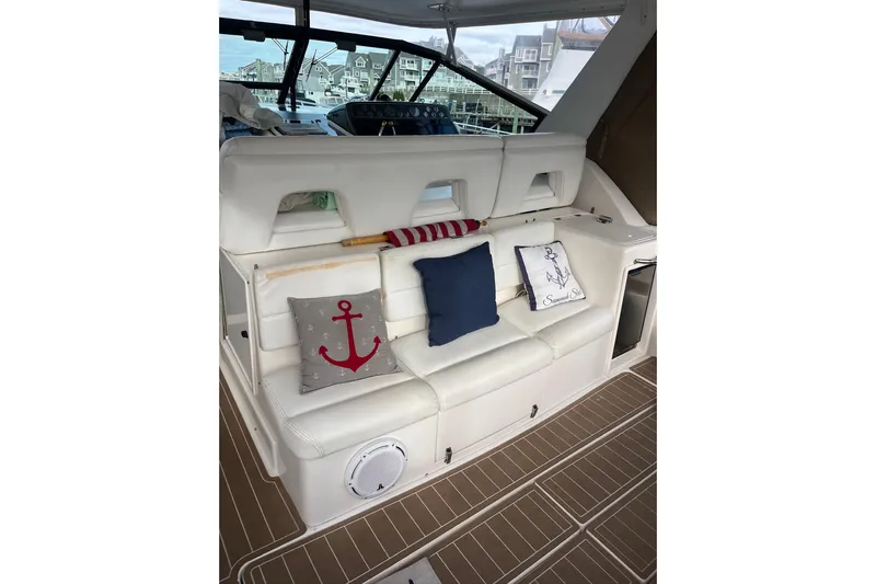 Summah Sled Yacht Photos Pics 1999 Tiara Yachts 4000 Express interior with white seating and nautical-themed cushions.