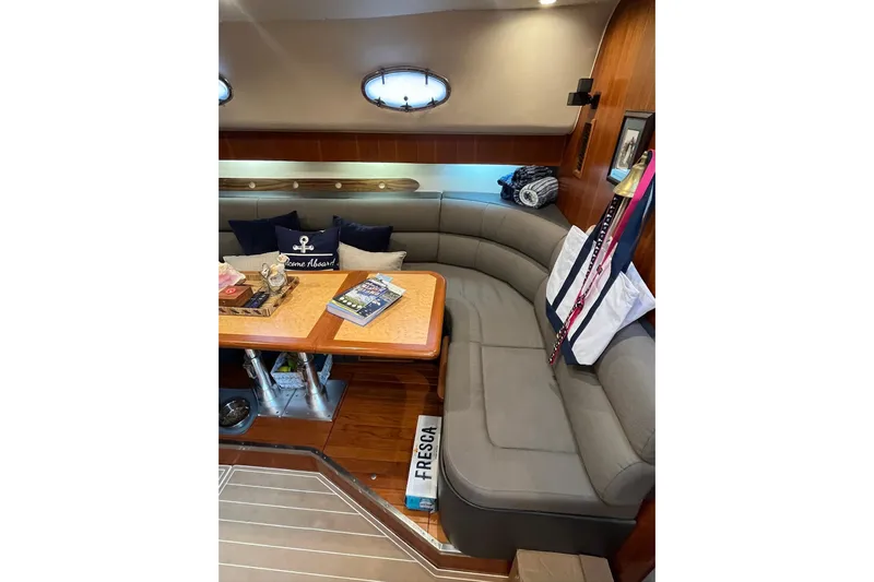 Summah Sled Yacht Photos Pics Luxurious interior of 1999 Tiara Yachts 4000 Express with cozy seating and nautical decor.