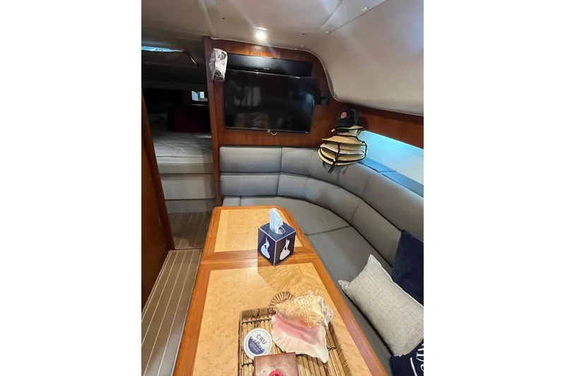 Summah Sled Yacht Photos Pics Interior of 1999 Tiara Yachts 4000 Express with cozy seating and elegant wood finishes.