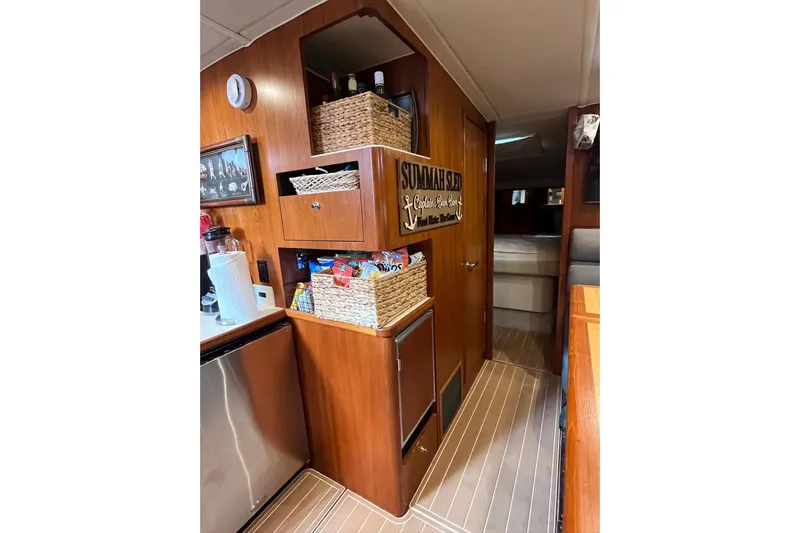 Summah Sled Yacht Photos Pics Interior of 1999 Tiara Yachts 4000 Express with wooden cabinetry and storage baskets.