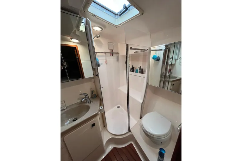 Summah Sled Yacht Photos Pics Bathroom interior of 1999 Tiara Yachts 4000 Express with shower, sink, and toilet.