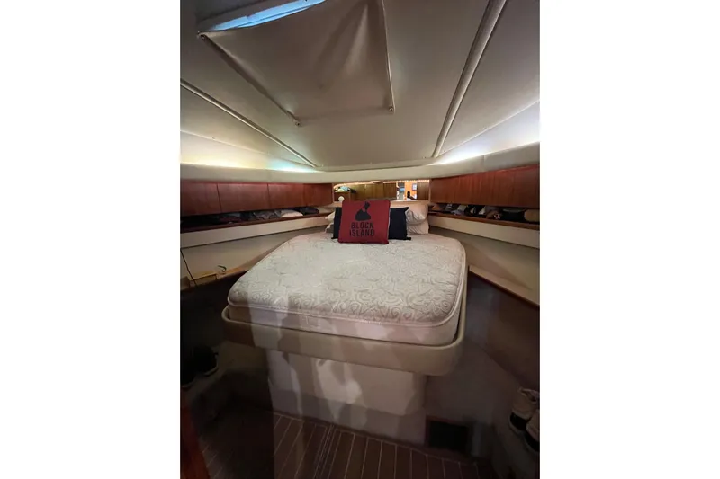 Summah Sled Yacht Photos Pics 1999 Tiara Yachts 4000 Express cabin interior with bed and wooden accents.