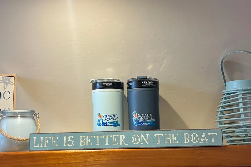 Summah Sled Yacht Photos Pics "Life is better on the boat" sign with can coolers and lantern.