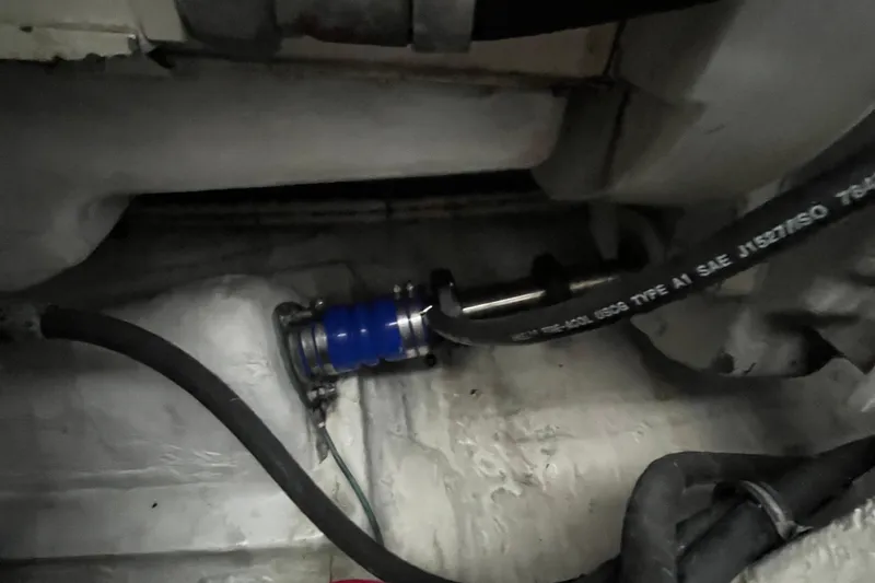 Summah Sled Yacht Photos Pics Engine compartment of a 1999 Tiara Yachts 4000 Express, showing hoses and fittings.