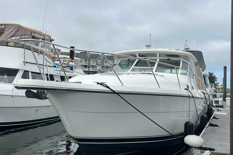 Summah Sled Yacht Photos Pics 1999 Tiara Yachts 4000 Express docked at marina, overcast sky.