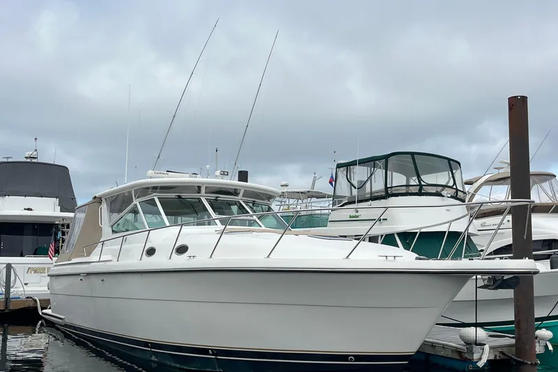 Summah Sled Yacht Photos Pics 1999 Tiara Yachts 4000 Express docked at marina under cloudy sky.