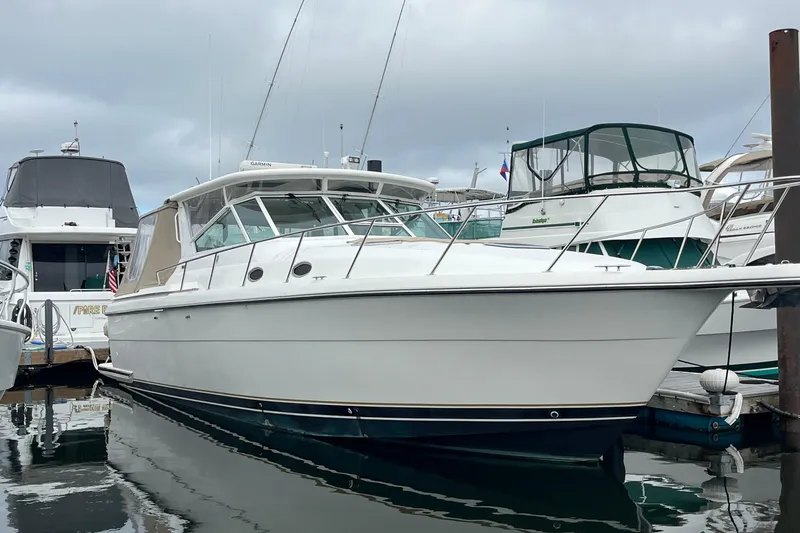Summah Sled Yacht Photos Pics 1999 Tiara Yachts 4000 Express docked at marina, side view.