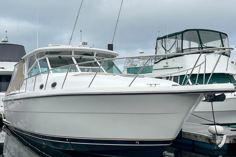 Summah Sled Yacht Photos Pics 1999 Tiara Yachts 4000 Express docked at marina, showcasing sleek design and white exterior.