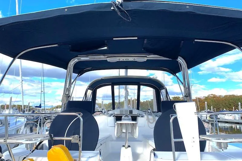 Sweet & Salty Yacht Photos Pics 2011 Hunter 39 sailboat cockpit with blue canopy and marina background.