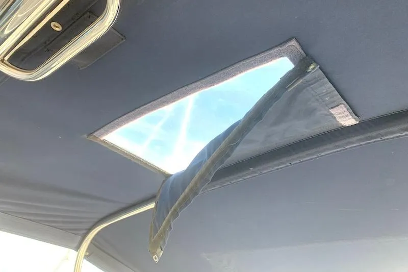 Sweet & Salty Yacht Photos Pics Open hatch on 2011 Hunter 39 sailboat, showing sunlight through canvas cover.