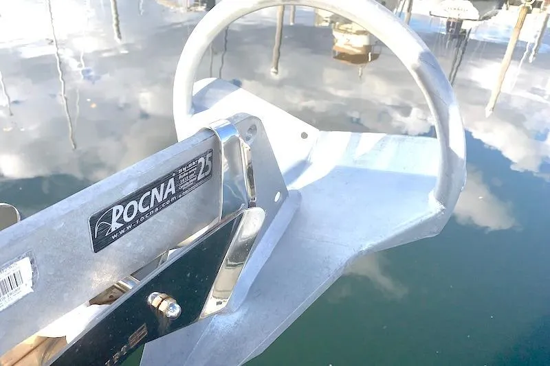 Sweet & Salty Yacht Photos Pics Rocna 25 anchor on a 2011 Hunter 39 sailboat, reflecting in calm marina waters.