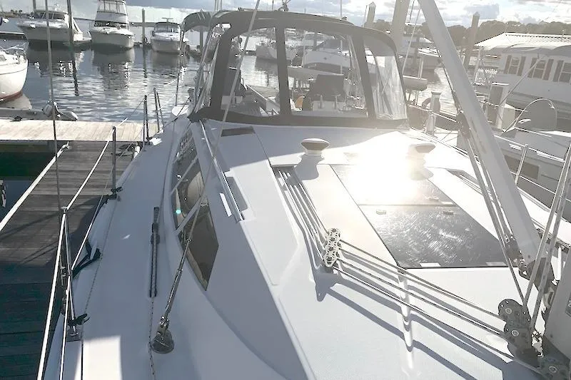 Sweet & Salty Yacht Photos Pics 2011 Hunter 39 sailboat docked at marina, sunlit deck, surrounded by other boats.