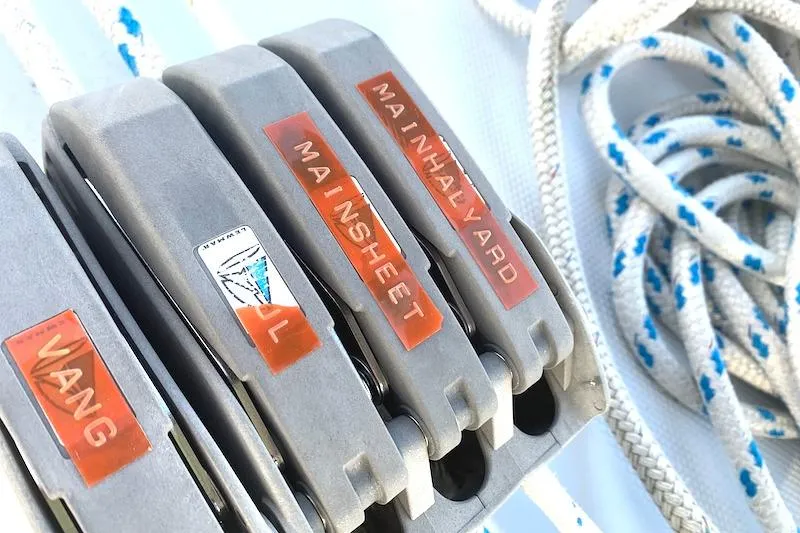 Sweet & Salty Yacht Photos Pics Close-up of sailing rope clutches labeled "Vang," "Main Sheet," and "Main Halyard" on a 2011 Hunter 39.