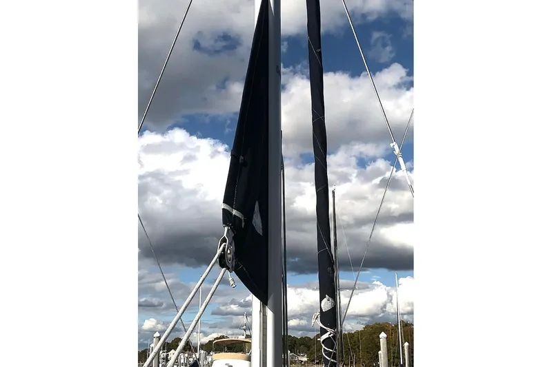 Sweet & Salty Yacht Photos Pics Sailboat mast and rigging against cloudy sky, Hunter 39, 2011 model.