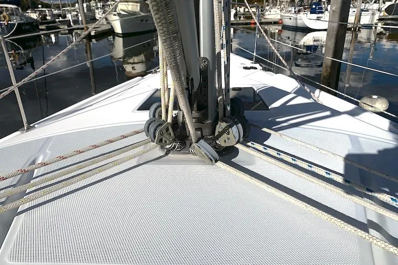 Sweet & Salty Yacht Photos Pics Deck view of a 2011 Hunter 39 sailboat with rigging and ropes in a marina.