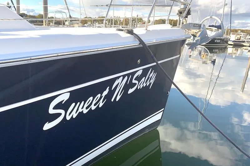 Sweet & Salty Yacht Photos Pics Hunter 39 sailboat "Sweet N' Salty" docked, reflecting in calm marina waters.