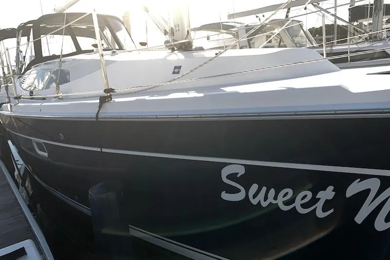 Sweet & Salty Yacht Photos Pics 2011 Hunter 39 sailboat docked, featuring sleek design and "Sweet N" name on hull.
