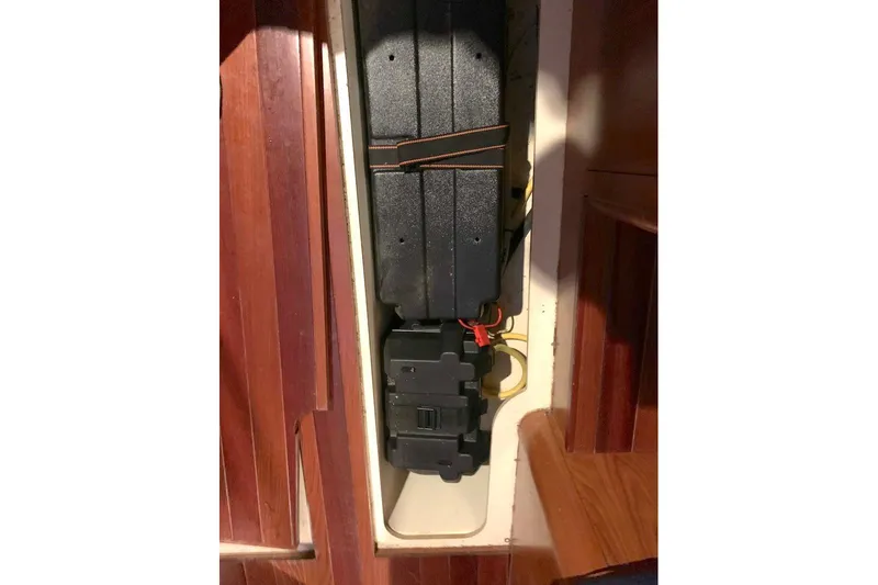 Sweet & Salty Yacht Photos Pics Battery compartment of a 2011 Hunter 39 sailboat, featuring secured black battery boxes.