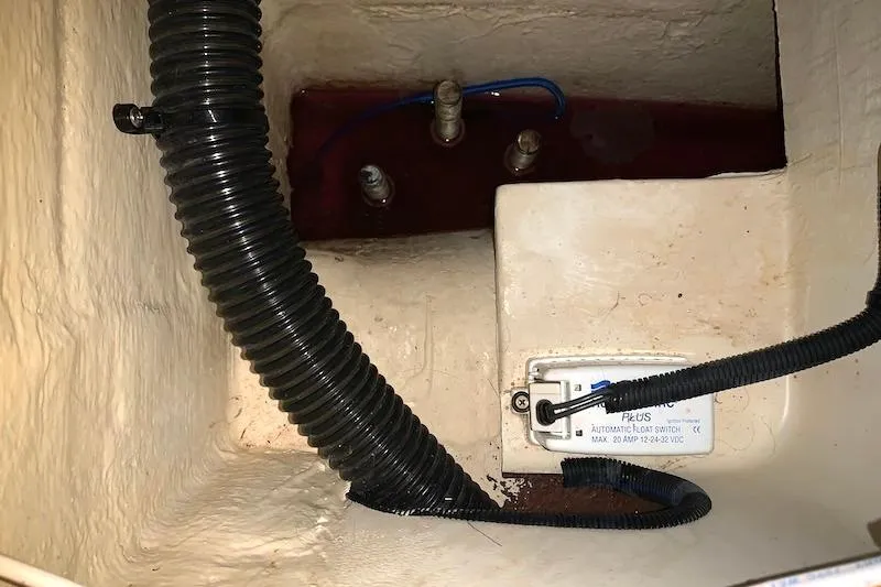 Sweet & Salty Yacht Photos Pics Bilge area of a 2011 Hunter 39 sailboat with wiring and hoses visible.