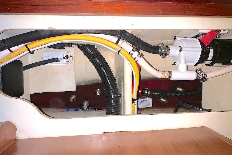 Sweet & Salty Yacht Photos Pics 2011 Hunter 39 yacht plumbing system with hoses and pump components.