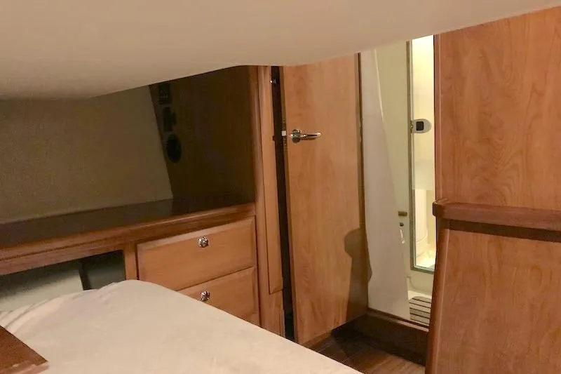 Sweet & Salty Yacht Photos Pics Interior cabin of 2011 Hunter 39 sailboat with wooden furnishings and bathroom access.