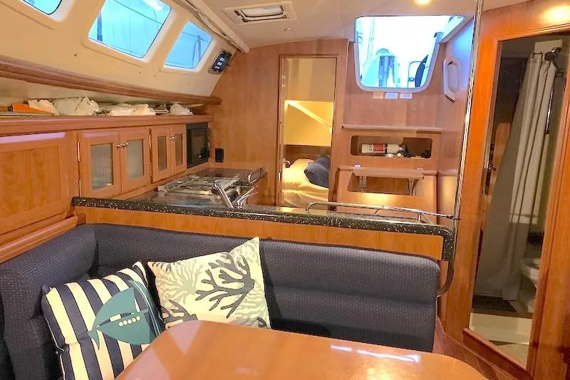 Sweet & Salty Yacht Photos Pics Interior of 2011 Hunter 39 sailboat with cozy seating and wooden cabinetry.
