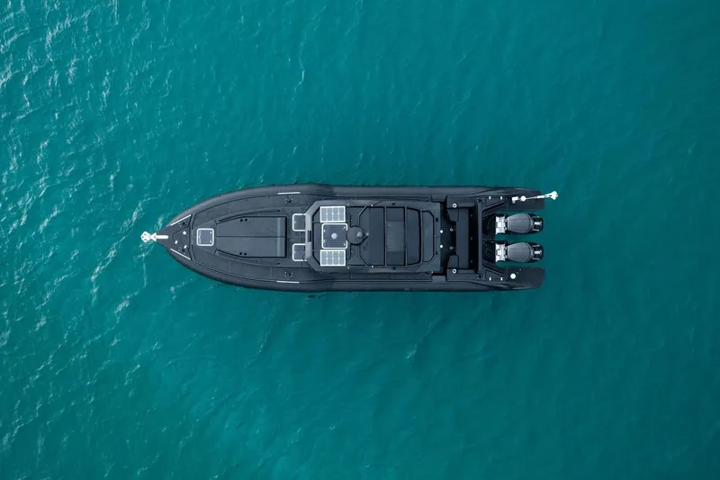  Yacht Photos Pics Aerial view of 2023 Rafnar 1100 C boat on turquoise water.