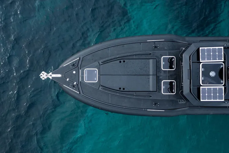  Yacht Photos Pics Top view of 2023 Rafnar 1100 C boat with solar panels on blue water.