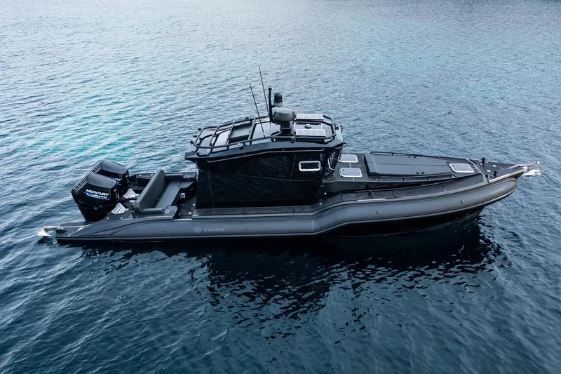  Yacht Photos Pics 2023 Rafnar 1100 C boat on calm blue water, featuring sleek design and Mercury engines.