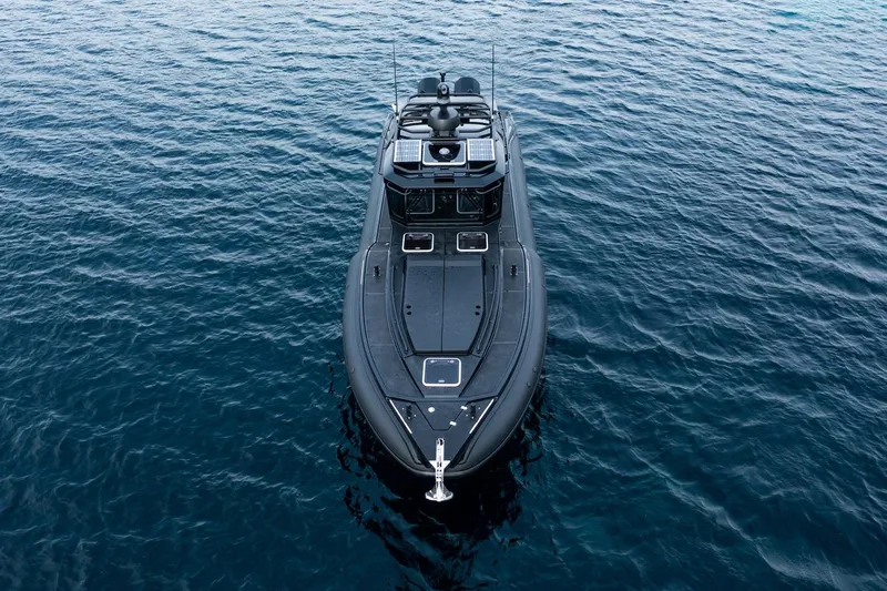  Yacht Photos Pics 2023 Rafnar 1100 C boat on calm blue water, aerial view.